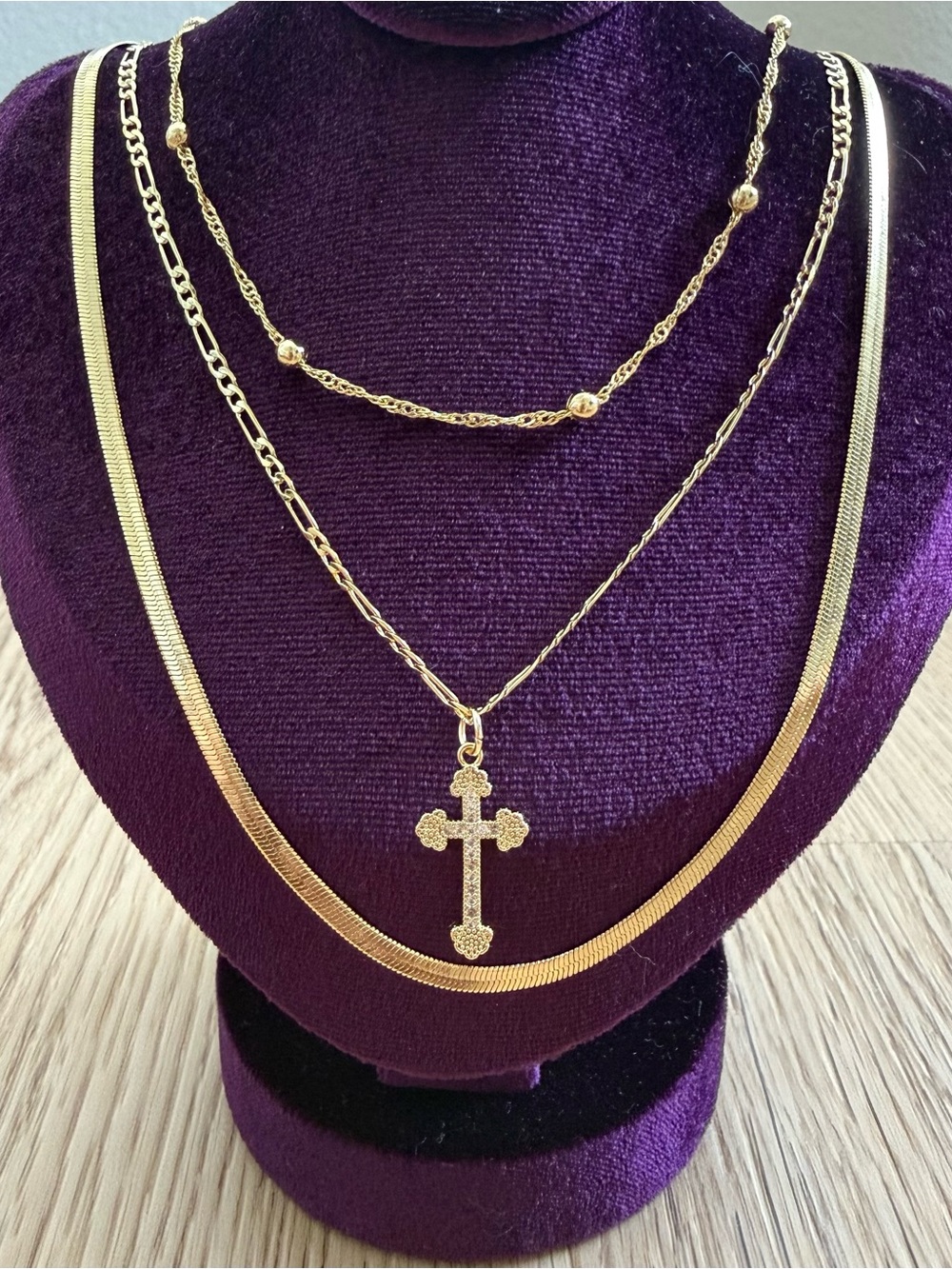Gold colored layered necklace set with cross pendant